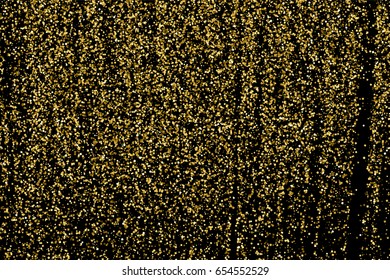 Gold glitter texture isolated on black. Amber particles color. Celebratory background. Golden explosion of confetti.