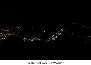 Gold glitter texture on a black background. Wave-like streams of golden-colored particles, an explosion of sparkling confetti. Festive background.