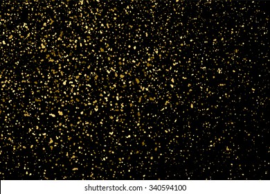 Gold glitter texture on a black background. Holiday background. Golden explosion of confetti. Golden grainy abstract  texture on a black  background. Design element. Vector illustration,eps 10.