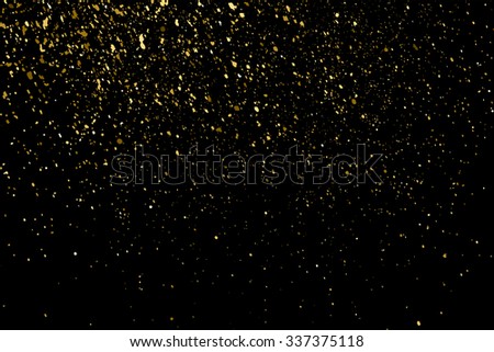 Gold glitter texture on a black background. Holiday background. Golden explosion of confetti. Golden grainy abstract  texture on a black  background. Design element. Vector illustration,eps 10.