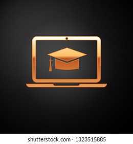 Gold Graduation cap on screen laptop icon isolated on black background. Online learning or e-learning concept. Vector Illustration