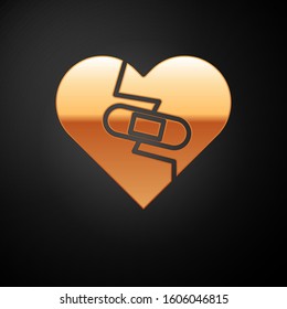Gold Healed broken heart or divorce icon isolated on black background. Shattered and patched heart. Love symbol. Valentines day.  Vector Illustration