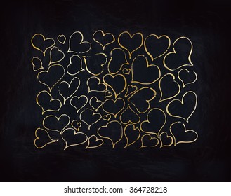 Gold hearts on dark textured black backdrop