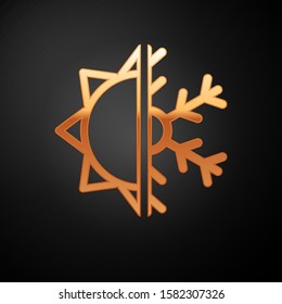 Gold Hot and cold symbol. Sun and snowflake icon isolated on black background. Winter and summer symbol.  Vector Illustration