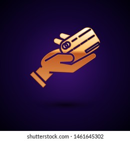 Gold Human hand holding with credit card icon isolated on dark blue background. Online payment. Pay by card. Financial operations.  Vector Illustration