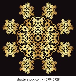 Gold lace pattern on a black background. Gold mandala. Gold pattern.

