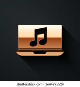 Gold Laptop with music note symbol on screen icon isolated on black background. Long shadow style. Vector Illustration