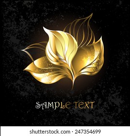 Gold leaves on dark textural background.