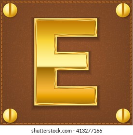 gold letter E on brown  leather plate 