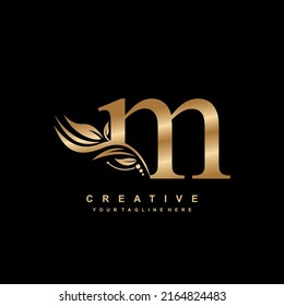 gold letter M logo design with luxury and beautiful ornaments. M Monogram. M typography. golden feather logo