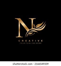 gold letter N logo design with luxurious and beautiful leaf ornament. N Monogram. N typography. gold feather logo. initial letter N logo