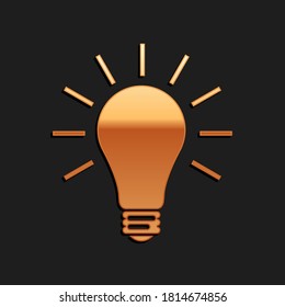 Gold Light bulb with rays shine icon isolated on black background. Energy and idea symbol. Lamp electric. Long shadow style. Vector.