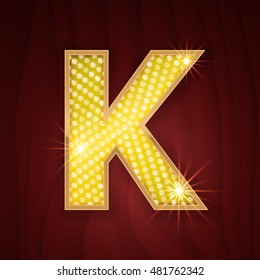 Gold light lamp bulb letter K. Sparkling lightning glitter shine alphabet for light board. Musical show style design for lettering