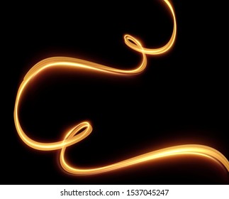 Gold light trail effect on black background. Magic light. Gold glowing neon line. Glowing swirl luxury golden light effect.