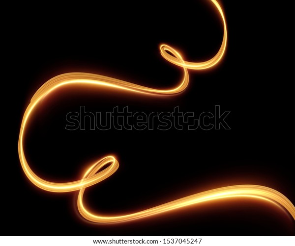 Gold\
light trail effect on black background. Magic light. Gold glowing\
neon line. Glowing swirl luxury golden light\
effect.