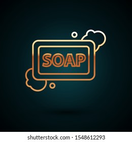 Gold line Bar of soap with foam icon isolated on dark blue background. Soap bar with bubbles.  Vector Illustration
