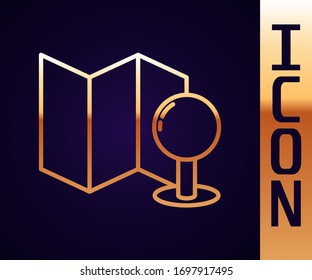 Gold line Folded map with push pin icon isolated on black background.  Vector Illustration