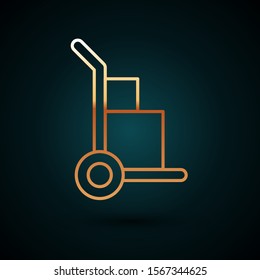 Gold line Hand truck and boxes icon isolated on dark blue background. Dolly symbol.  Vector Illustration