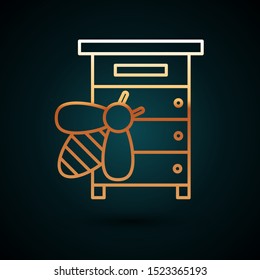 Gold line Hive for bees icon isolated on dark blue background. Beehive symbol. Apiary and beekeeping. Sweet natural food.  Vector Illustration