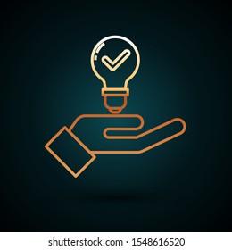 Gold line Light bulb in hand icon isolated on dark blue background. Concept of idea.  Vector Illustration