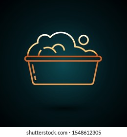 Gold line Plastic basin with soap suds icon isolated on dark blue background. Bowl with water. Washing clothes, cleaning equipment.  Vector Illustration