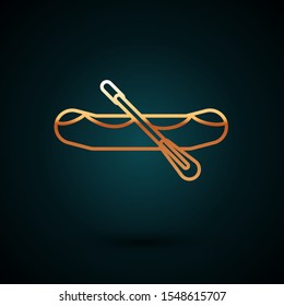 Gold line Rafting boat icon isolated on dark blue background. Inflatable boat with paddles. Water sports, extreme sports, holiday, vacation.  Vector Illustration