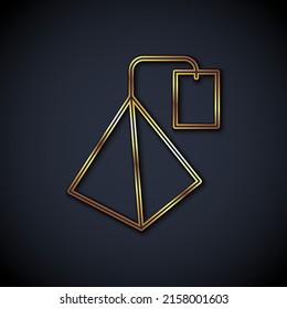 Gold line Tea bag icon isolated on black background.  Vector