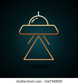 Gold line UFO flying spaceship icon isolated on dark blue background. Flying saucer. Alien space ship. Futuristic unknown flying object.  Vector Illustration