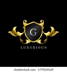 Gold Luxury Shield G Letter Logo. Elegance logo vector template made of wide silver alphabet font on shield frame ornate luxury style.