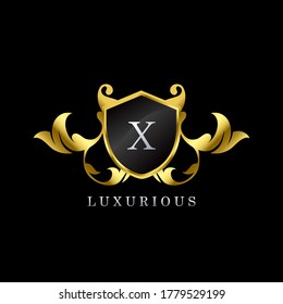 Gold Luxury Shield X Letter Logo. Elegance logo vector template made of wide silver alphabet font on shield frame ornate luxury style.