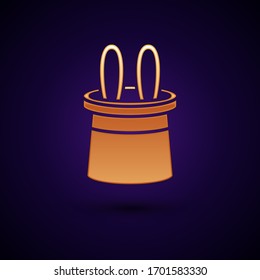 Gold Magician hat and rabbit ears icon isolated on black background. Magic trick. Mystery entertainment concept.  Vector Illustration