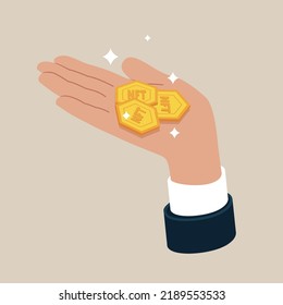 Gold NFT token coin in hand businessman. Concept of charity, donate. Stack of coins.