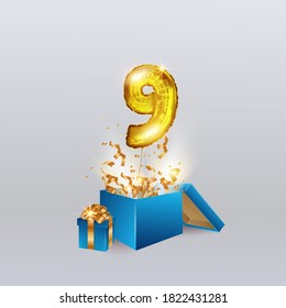 Gold number nine 9 a metal ball flies out of the box with a serpentine and a gift. Party decoration with Golden balloons. Anniversary sign for a happy holiday, celebration, birthday, carnival.