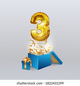 Gold number three 3 a metal ball flies out of the box with a serpentine and a gift. Party decoration with Golden balloons. Anniversary sign for a happy holiday, celebration, birthday, carnival.