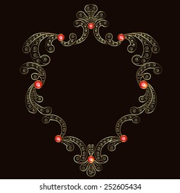 Gold openwork frame adorned with rubies on black