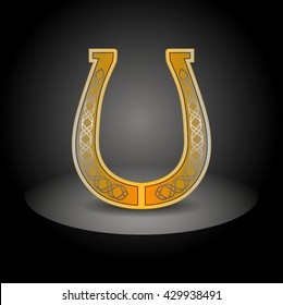 Gold ornate horseshoe on a black background. Vector illustration