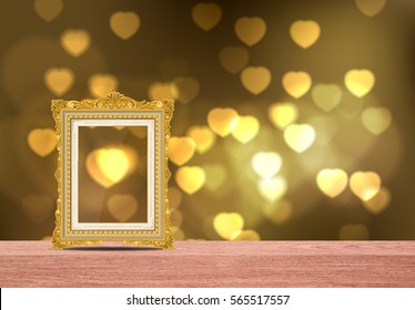 gold picture frame on table with heart bokeh
