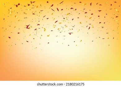 Gold pieces of foil sparkle against a background that is tinted with oranges, subtle yellow tones. Golden glitter festive pattern. Golden background
