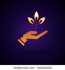 Gold Plant in hand of environmental protection icon isolated on dark blue background. Seed and seedling. Planting sapling. Ecology concept.  Vector Illustration
