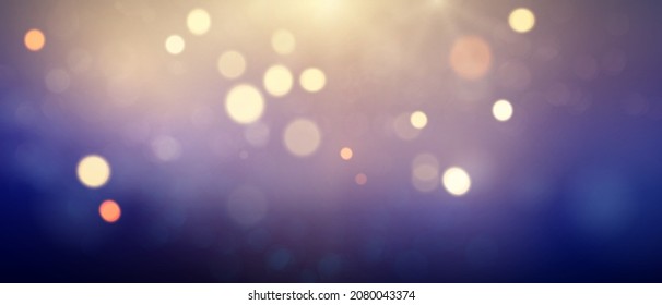 Gold and purple glitter stars on abstract blue background are used for celebrations.