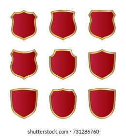 Gold and red shield shape icons set. Logo emblem metallic signs isolated on white background. Shape shield symbol of security, protection or armor, safe. Shiny element design Vector illustration