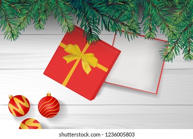 gold ribbon and gift box is open on the top of wooden table with christmas tree. concept design of surprised present gift in Christmas or new year in vector. it also use for marketing and sale