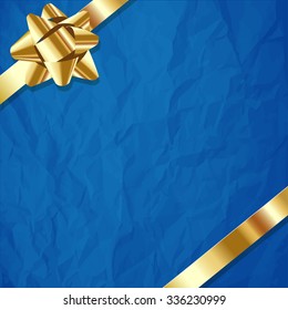 Gold ribbon on a crumpled paper blue background.