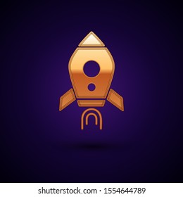 Gold Rocket ship with fire icon isolated on dark blue background. Space travel.  Vector Illustration