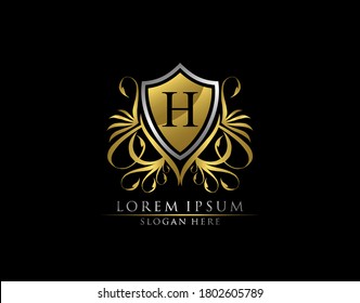 Gold Royal Shield H Letter Logo. Graceful Elegant gold shield icon design.  