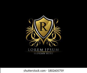 Gold Royal Shield R Letter Logo. Graceful Elegant gold shield icon design.  