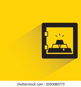 gold in safe with shadow on yellow background