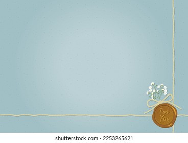 Gold sealing stamp and baby's breath, burlap cord, blue paper background