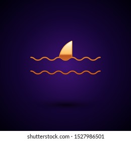 Gold Shark fin in ocean wave icon isolated on dark blue background.  Vector Illustration