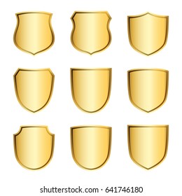 Gold shield shape icons set. 3D golden emblem signs isolated on white background. Symbol of security, power, protection. Badge shape shield graphic design Vector illustration